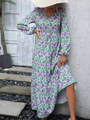 Vibrant paisley print V-neck dress with balloon sleeves and drawstring waist.