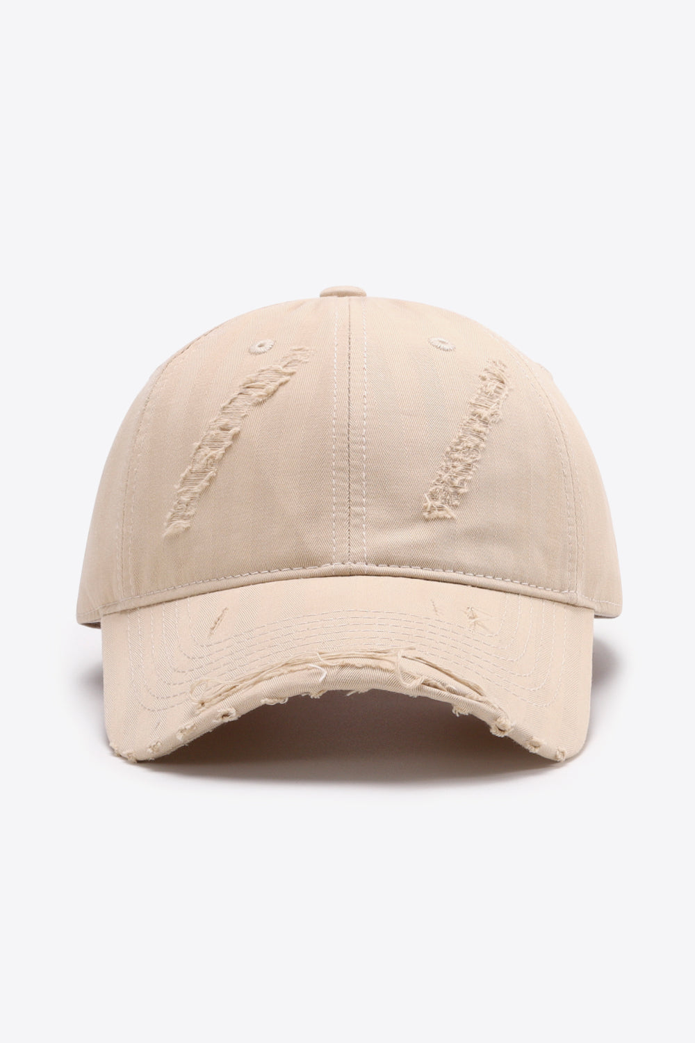 Cream distressed baseball cap with frayed brim and distressed details on crown.