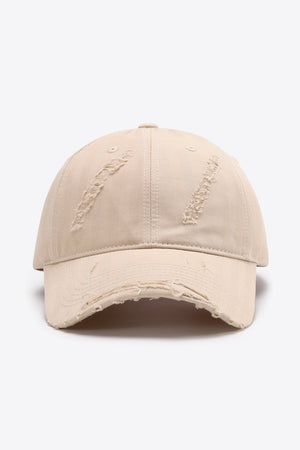 Cream distressed baseball cap with frayed brim and distressed details on crown.