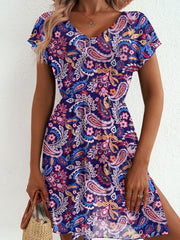 Vibrant paisley print mini dress with V-neck, short sleeves, and a thigh slit.