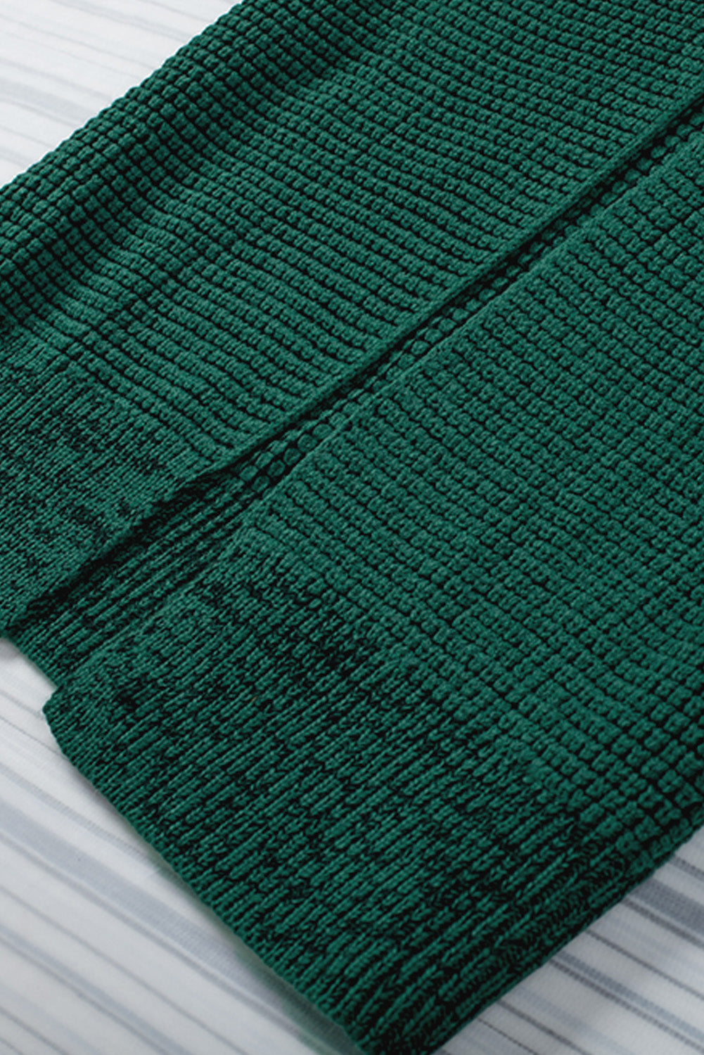 Textured acrylic open cardigan in Black Forest green with a ribbed knit pattern.