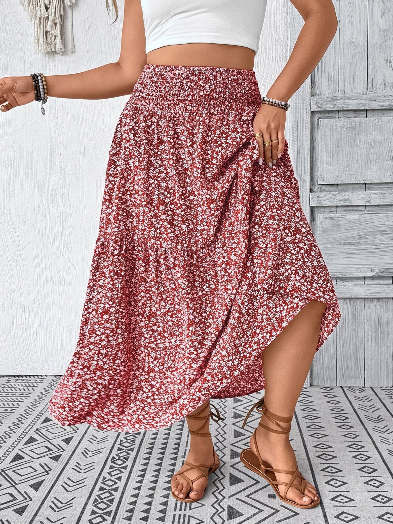 Tiered floral print midi skirt in dusty pink with smocked waist and airy fabric.