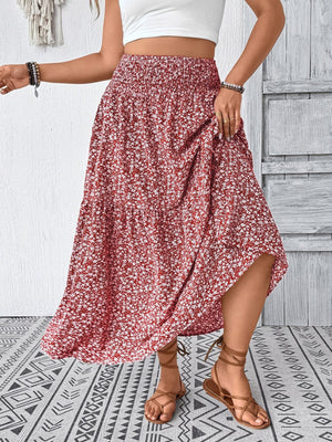 Tiered floral print midi skirt in dusty pink with smocked waist and airy fabric.