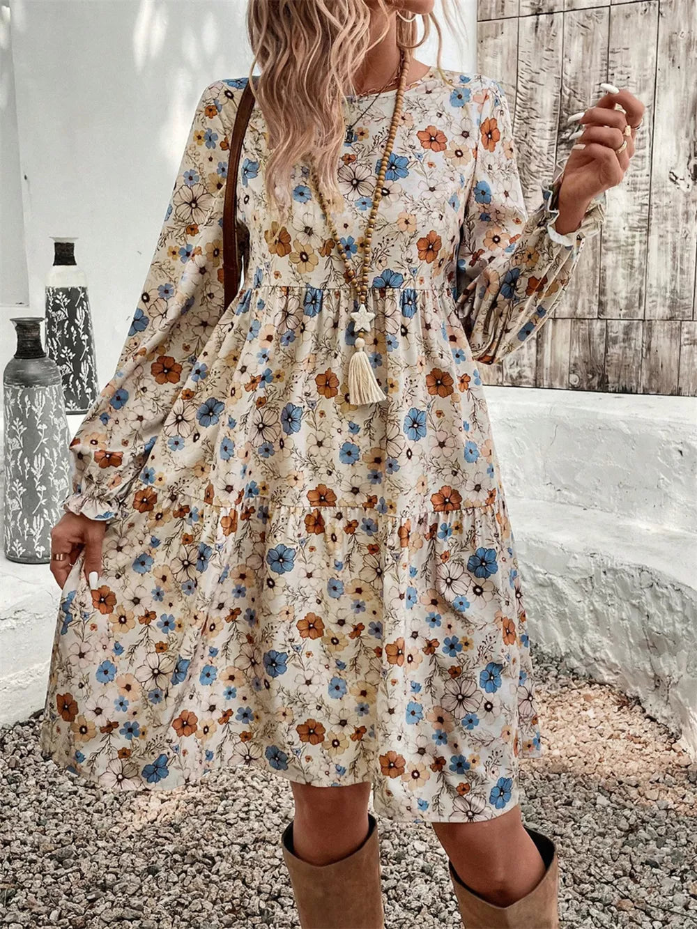 Floral tiered hem long sleeve dress with blue and orange flowers, boho style.