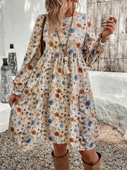 Floral tiered hem long sleeve dress with blue and orange flowers, boho style.