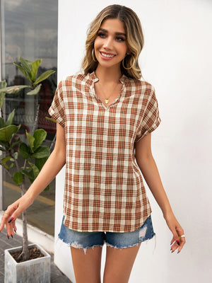 Caramel plaid henley blouse with notched neckline and short sleeves.