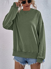 Moss green boxy sweatshirt with V-neck detail and ribbed cuffs and hem.
