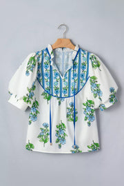 White polyester shirt with blue floral print, tie-neck, and ruffled collar.