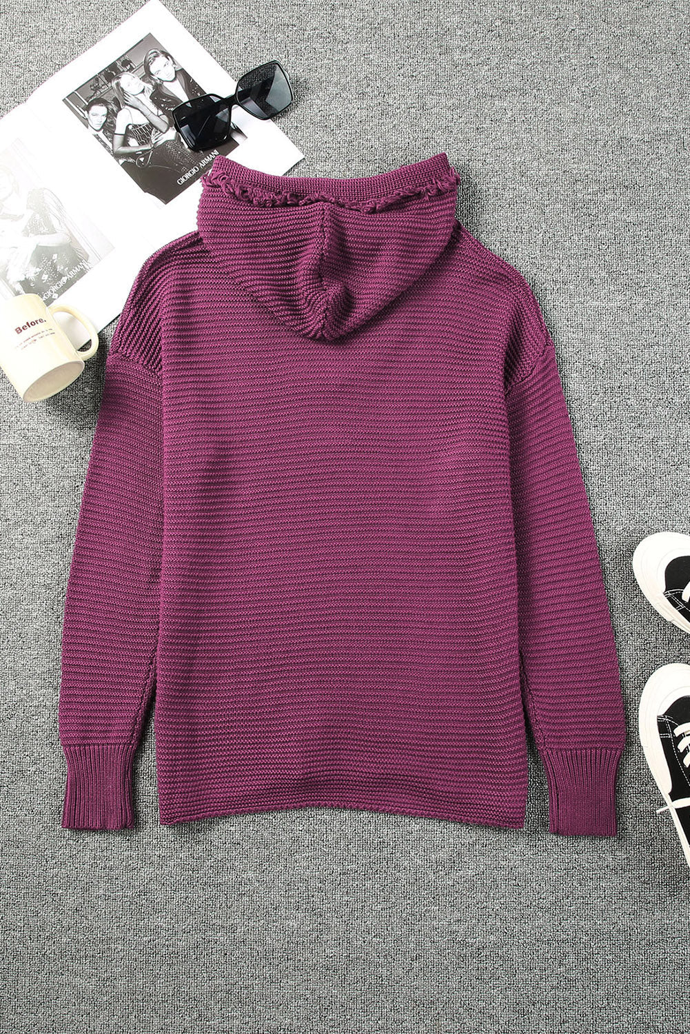 Burgundy textured knit hooded pullover sweater with fringe trim on hood.