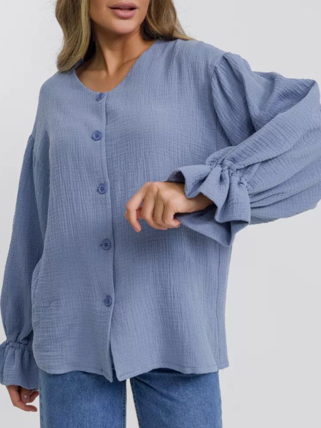Light blue textured blouse with puff sleeves and ruffled cuffs