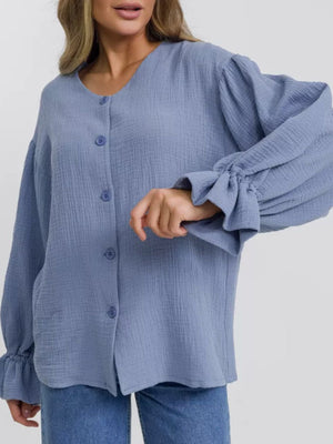 Light blue textured blouse with puff sleeves and ruffled cuffs