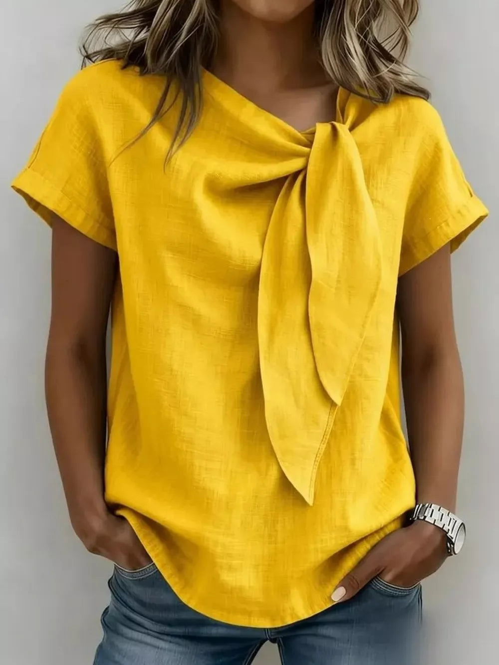 Yellow short sleeve shirt with bow-tie neck detail and relaxed fit.