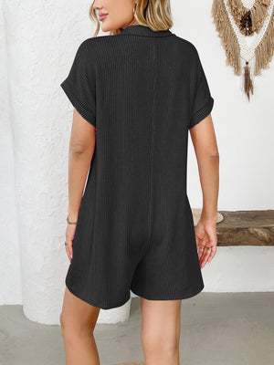 Black ribbed knit romper with patch pockets and button accents.