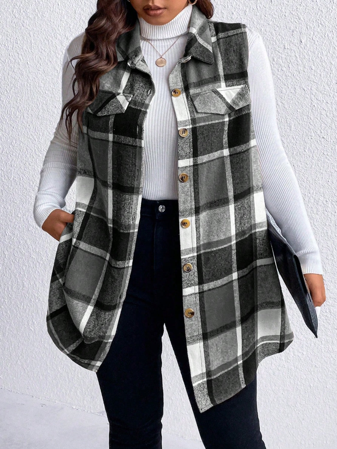 Oversized plaid shirt vest with button front and chest pockets, styled over a turtleneck.