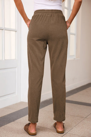 Corduroy drawstring trousers in mocha with slant pockets and a relaxed fit.
