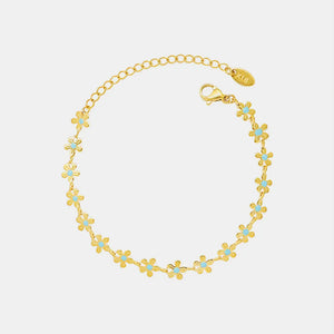 Gold daisy chain bracelet with blue enamel centers, 18K gold-plated.