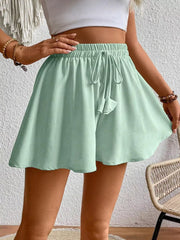 Green cotton chino shorts with drawstring waist and a-line cut.