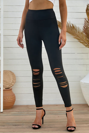 Black performance leggings with distressed knee slits and a high waist.