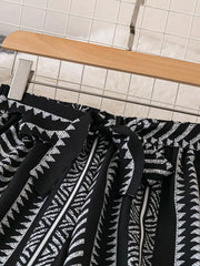Black geometric print maternity pants with adjustable tie bow detail