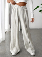 Light gray V-waistline palazzo sweatpants with center seams and a relaxed fit.