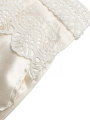 Lace-trimmed beige maternity wide-leg trousers with a high waist.