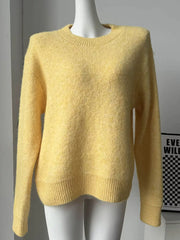 Pastel yellow knit sweater with crew neck and relaxed fit, ribbed hem and cuffs.