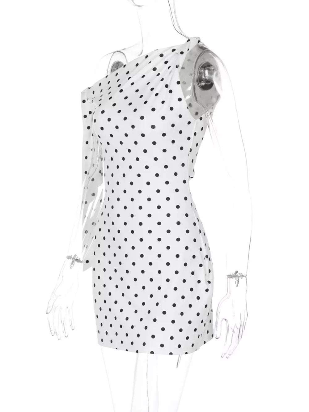 White polka dot mini dress with asymmetrical one-shoulder design and long sleeve.