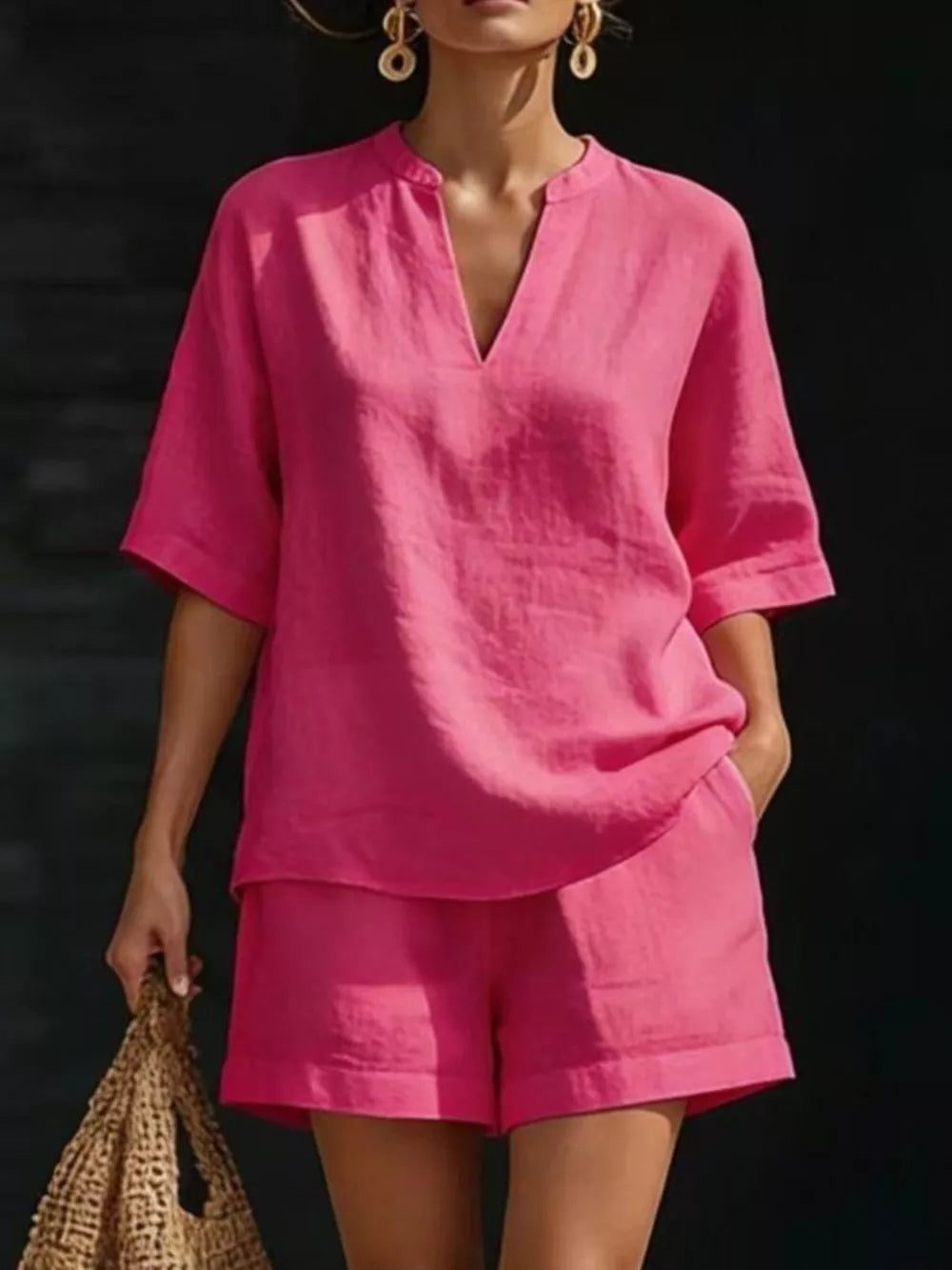 Fuchsia pink notched V-neck two-piece set with pockets and short sleeves.