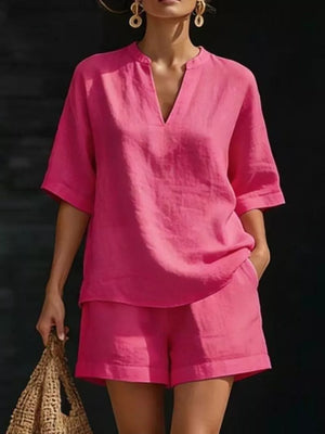 Fuchsia pink notched V-neck two-piece set with pockets and short sleeves.