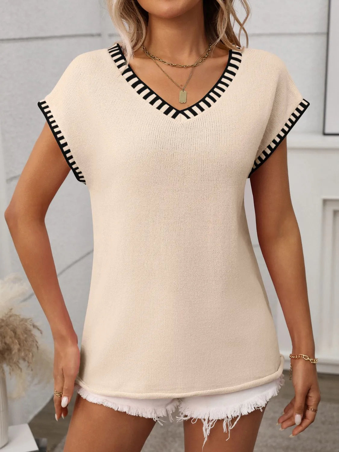 Tan knit v-neck sleeveless sweater with black trim detail