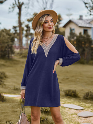 Navy cold shoulder mini dress with lace trim neckline and cuffs.