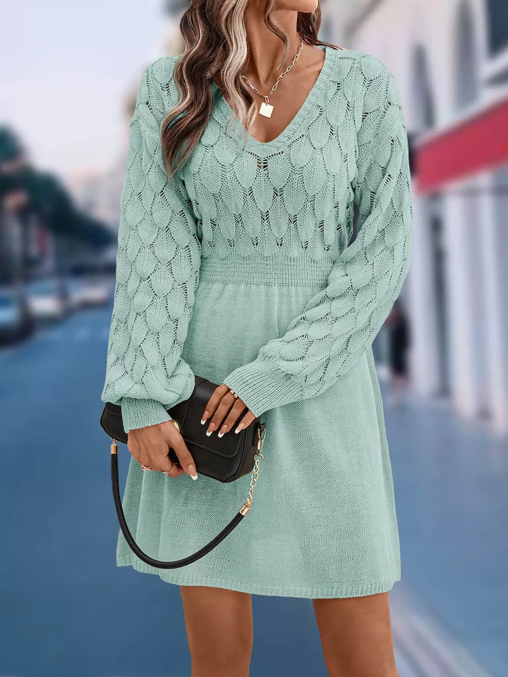 Teal openwork knit sweater dress with V-neck and cinched waist, above knee length.