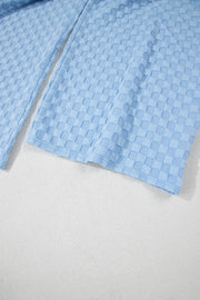 Light blue textured checkered button-strap palazzo jumpsuit detail