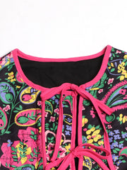 Paisley quilted jacket with tie closure in black with pink trim and floral print.