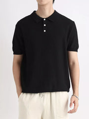 Black ribbed short sleeve polo shirt with classic collar and three white buttons.