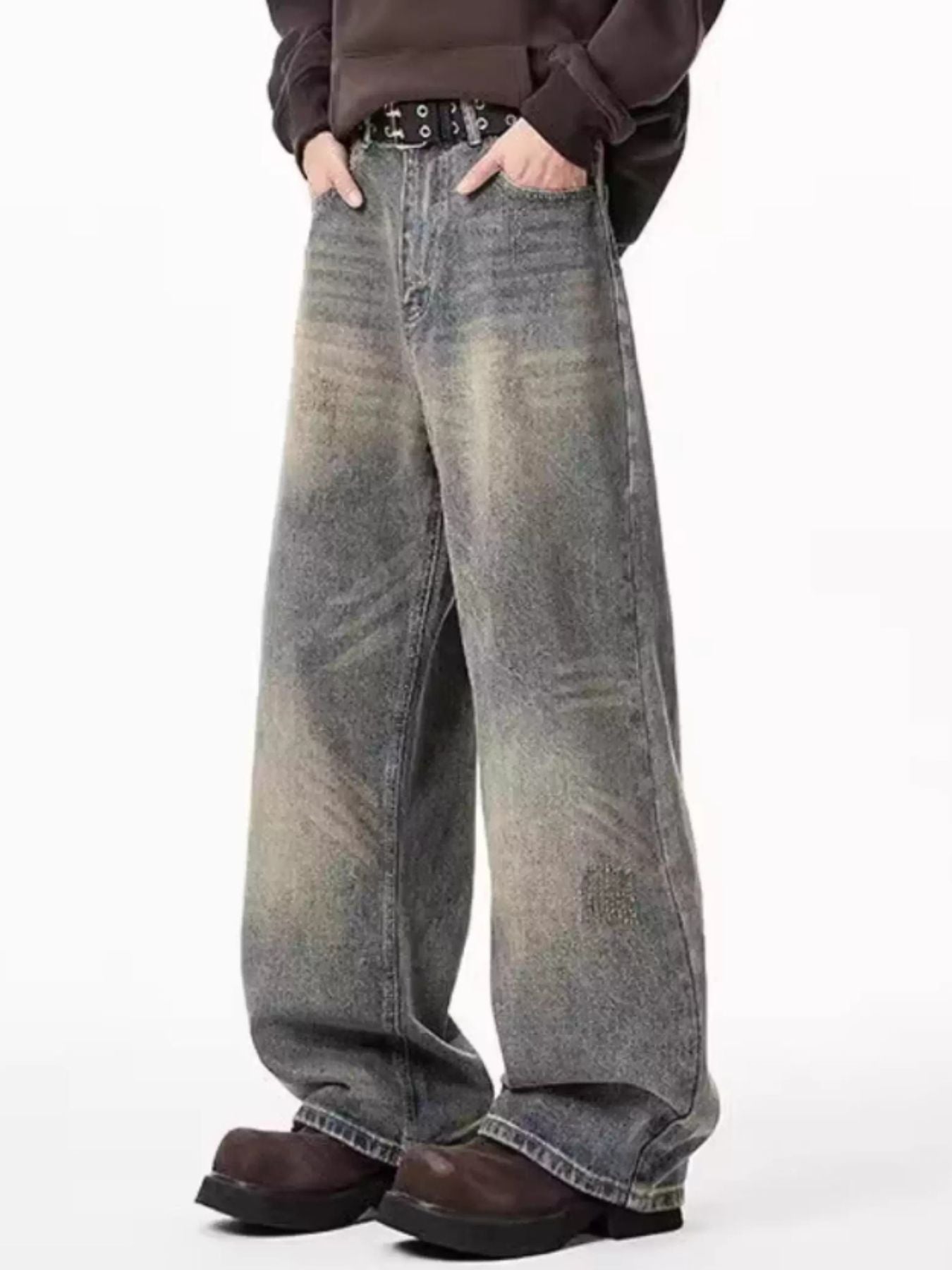 Men's belted wide-leg jeans in distressed blue denim with a relaxed fit.