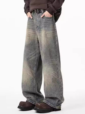 Men's belted wide-leg jeans in distressed blue denim with a relaxed fit.