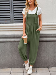 Olive green corduroy overalls with barrel leg and tie straps, worn with a white tee.