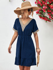 Dark blue A-line dress with Swiss dot texture, crochet trim V-neckline and short sleeves.