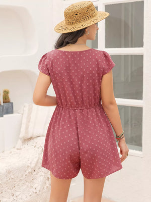 Rose pink Swiss dot romper with cap sleeves and elastic waist.
