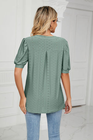 Sage perforated puff sleeve blouse with keyhole detail and eyelet pattern.
