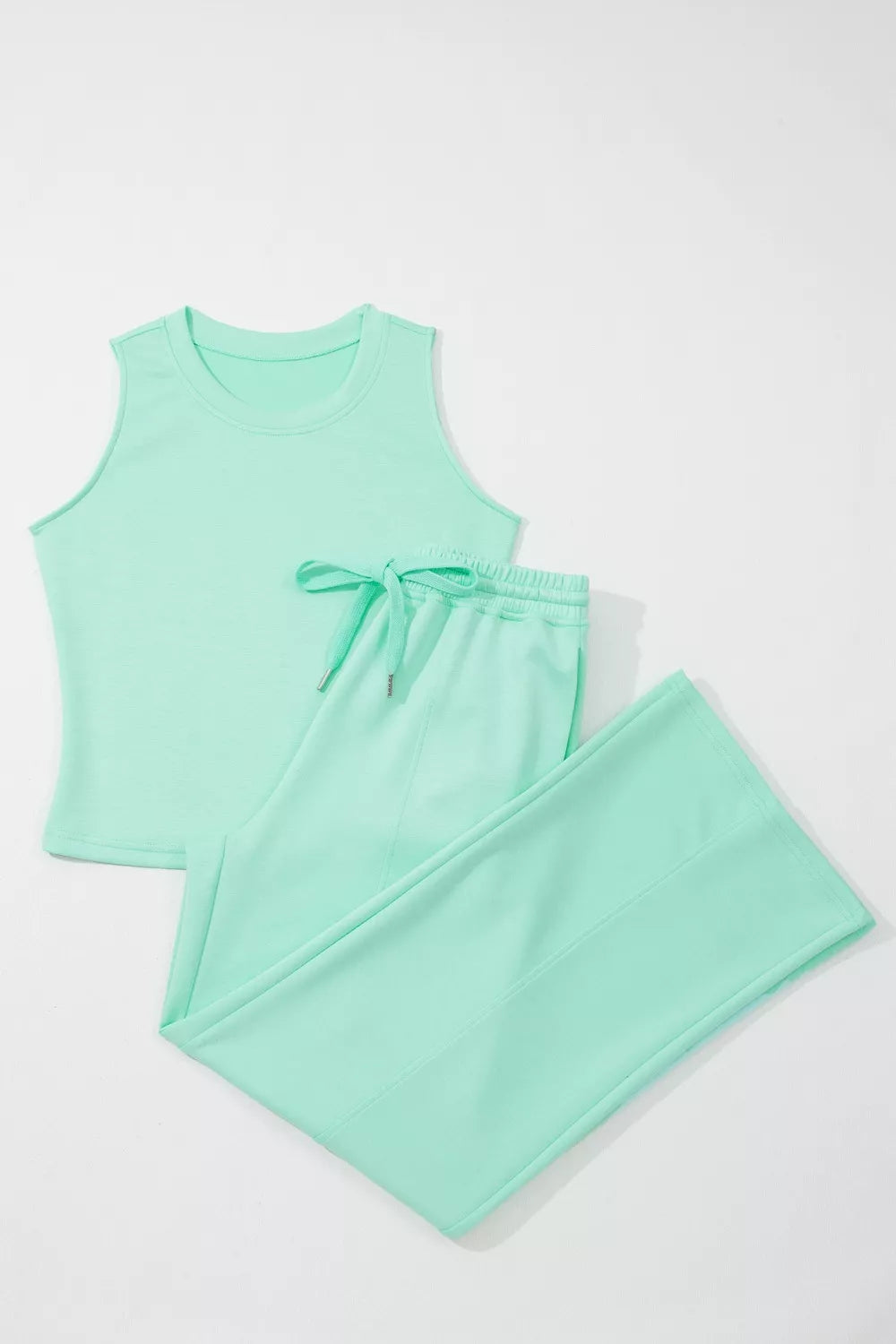 Mint green drawstring lounge set with sleeveless top and wide-leg pants.