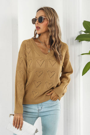 Camel v-neck knit pullover sweater with allover heart stitch pattern and long sleeves.