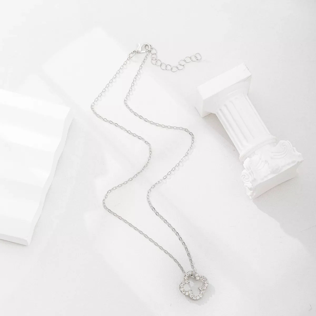 Silver clover pendant necklace with clear stones on a delicate chain