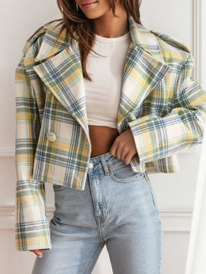 Boxy plaid cropped blazer in cream with yellow, green, and blue plaid. Features a double-breasted front and wide lapels.