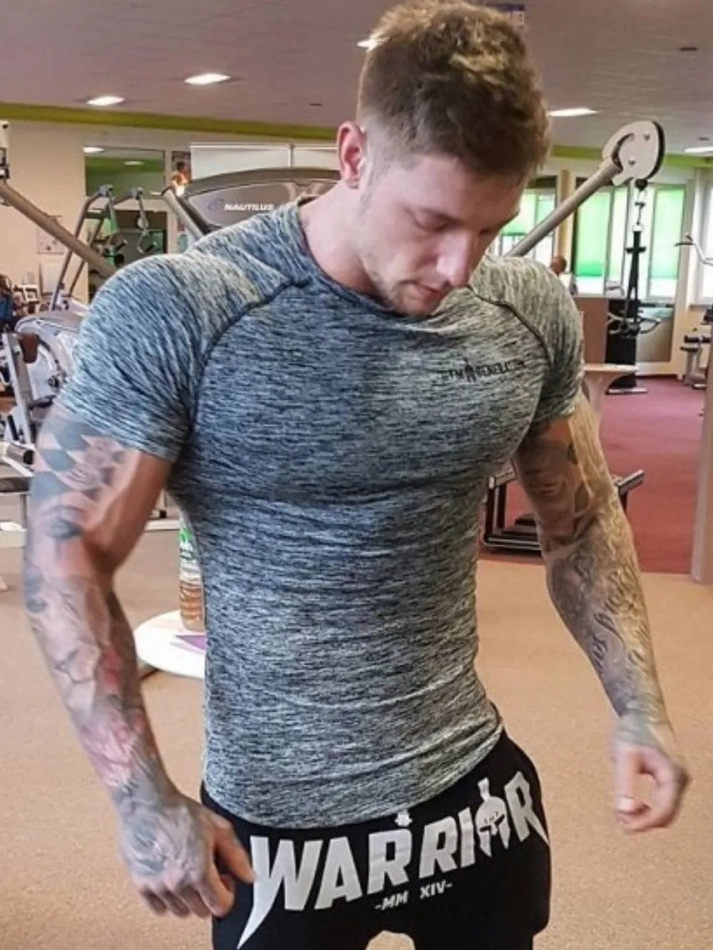 Performance knit gym tee in gray heather with short sleeves and crew neck.