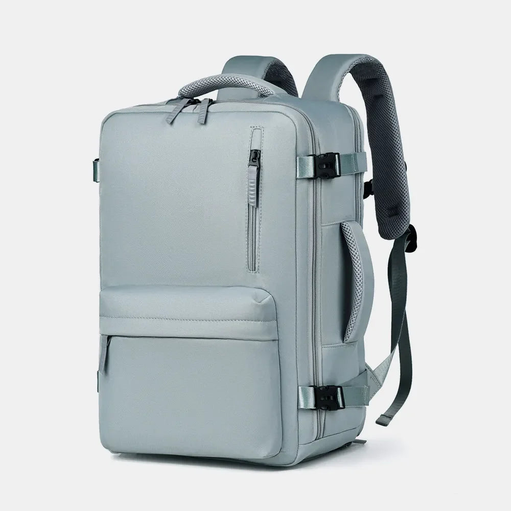 Travel backpack in beige with zippered front pocket and padded straps.