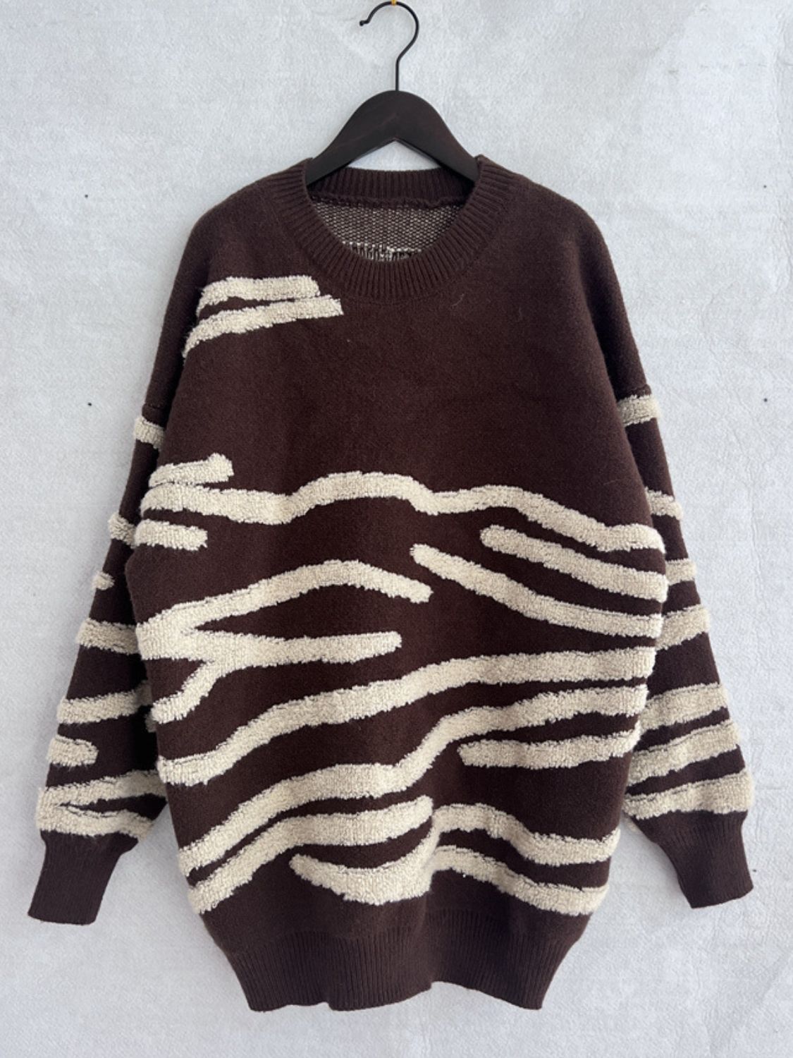 Brown acrylic crewneck sweater with textured cream stripes.