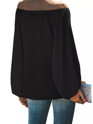 Black off-shoulder maternity blouse with balloon sleeves, styled with jeans and a clutch.