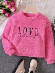 Fuzzy pink sweatshirt for kids with black "LOVE IS ALL YOU NEED" graphic.